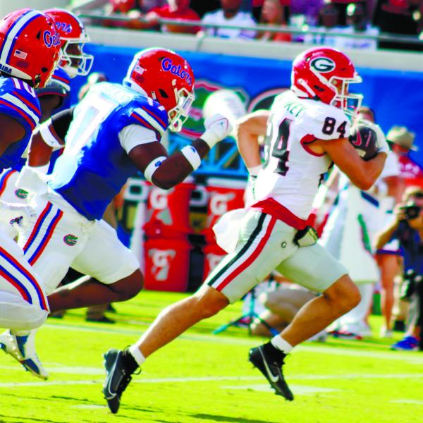 Georgia wide receiver Ladd McConkey (84) runs away from Florida defenders for a 41-yard touchdown. LANCE McCURLEY/Staff