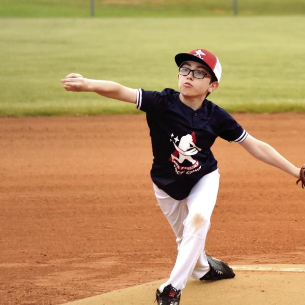 Is that a screwball that youngster just threw? We’ll have to ask Joe Cardwell, a former college pitcher at the University of South Carolina, who was on hand to help coach young ballplayers at Fisch Camp. T. MICHAEL STONE/Staff