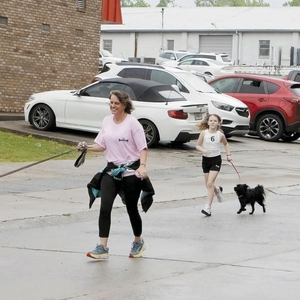Participants return from their 5K run through Greensboro on Saturday to support Circle of Friends. (LEIGH LOFGREN/Staff)