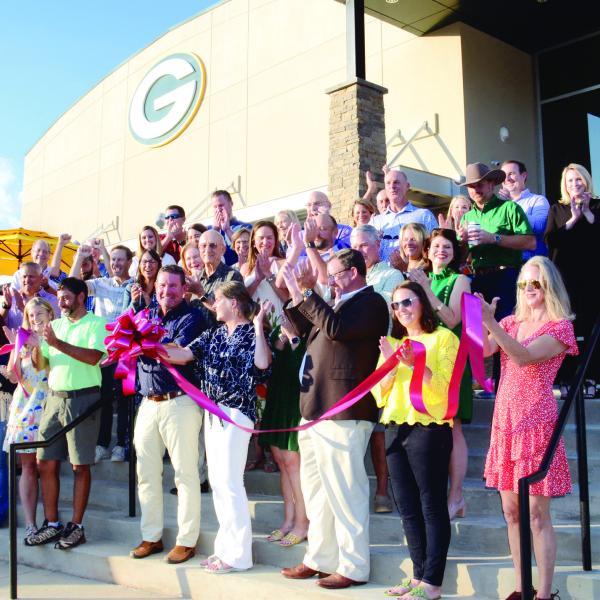 Head of Gatewood Schools Jeff Decker (center with bow) made the cut to officially open Gatewood’s new high school, though the building has been in use since school resumed early last month. IAN TOCHER/Staff