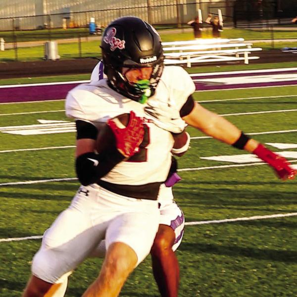 Morgan County wide receiver Cole Wesley fights for extra yardage during a scrimmage against Cherokee Bluff on Aug. 13. JATAVIOUS WARD/Contributed