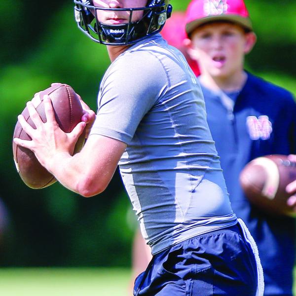 Junior quarterback Gunner Braswell prepares to throw a pass downfield during a 7-on-7 competition at UGA in June. LANCE McCURLEY/Staff