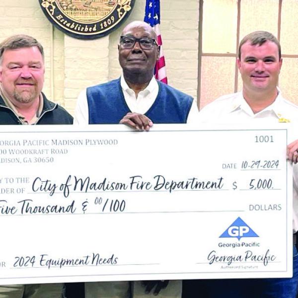 (L-R) Kevin Whitley, Josey Cameron, Georgia-Pacific plant manager Wesley Stone, Mayor Fred Perriman, Assistant Fire Chief Daniel Pennington, Tracy Brewer, and Georgia-Pacific assistant plant manager Scott Lamar at the check presentation for the Madison Fire Department. CONTRIBUTED