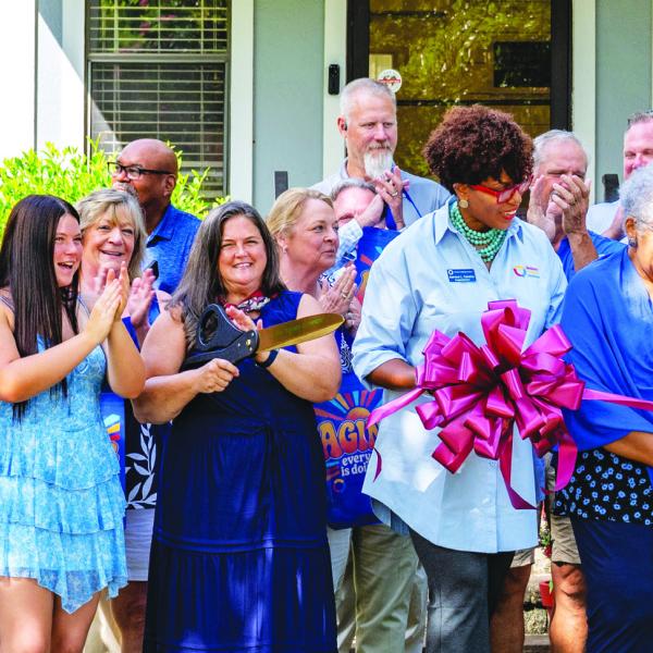 Employees and supporters of Seniors Helping Seniors Mid-South Georgia cheer as the ribbon is cut late last Tuesday to officially recognize the opening of the unique, new facility in Putnam County. CONTRIBUTED