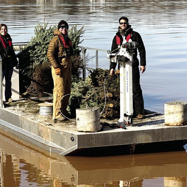 Georgia Power, the Georgia Wildlife Resource Department, and the Lake Oconee Bass Masters Fishing Club help Rotary members sink Christmas trees repurposed as fish habitats. CONTRIBUTED