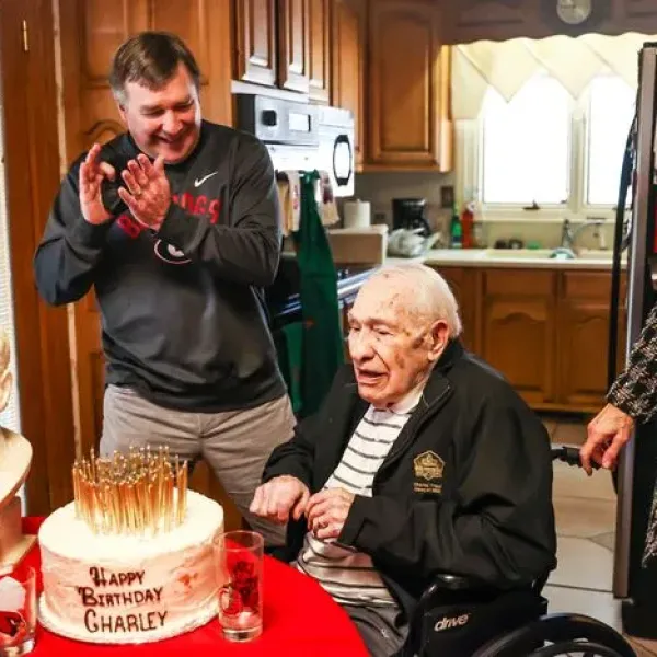 Georgia coach Kirby Smart applauds for Charley Trippi after Trippi blew out all the candles on his cake on his 100th birthday at his home in Athens. Trippi, one of the greatest players and athletes in Bulldogs history, died Wednesday. (Photo by Tony Walsh/UGA Athletics)