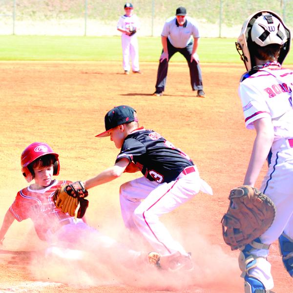 This runner beats the tag at home plate by an eyelash during one of the inaugural games at Morgan County’s new recreational complex. T. MICHAEL STONE/Staff