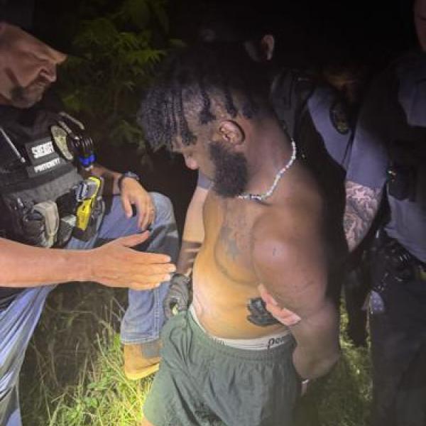 A Morgan County investigator secures suspect Daquan Unique Davis. CONTRIBUTED