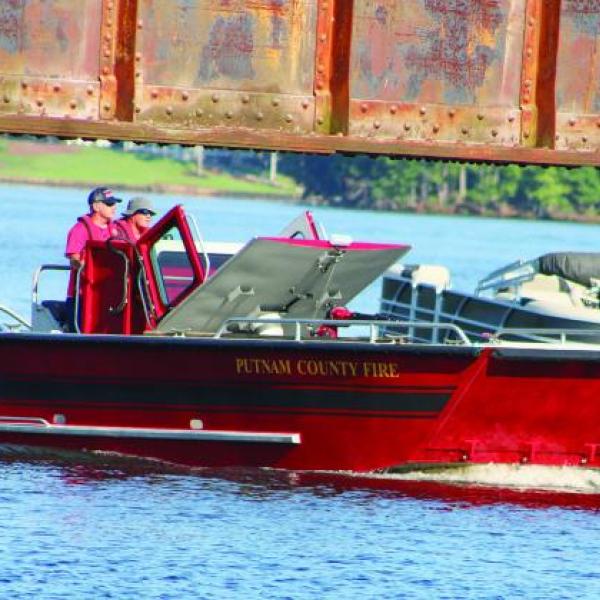 Putnam County Fire Department’s personnel scan the lake from “Sinclair 1” searching Lake Sinclair with other agencies for the missing jet ski rider. LYNN HOBBS/Staff