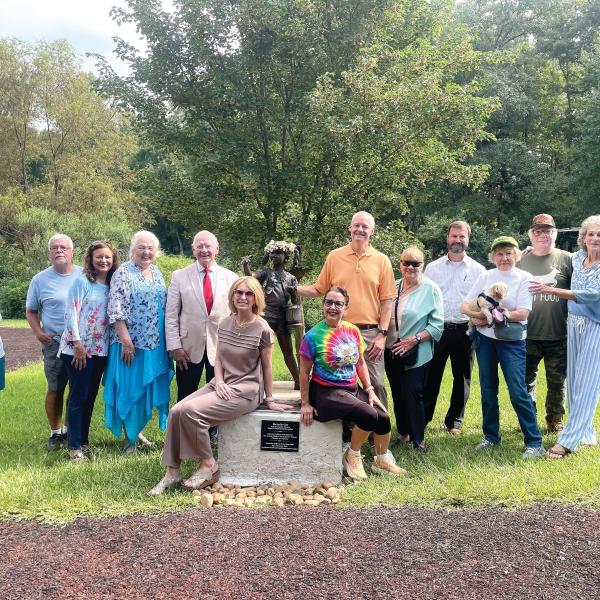 Butterflies & Blooms in the Briar Patch habitat founder Virginia Linch (far right), and the BBBP habitat’s supporters and friends gather around the “Butterfly Girl” to commemorate the reveal of the new addition at the habitat. LYNN HOBBS/Staff
