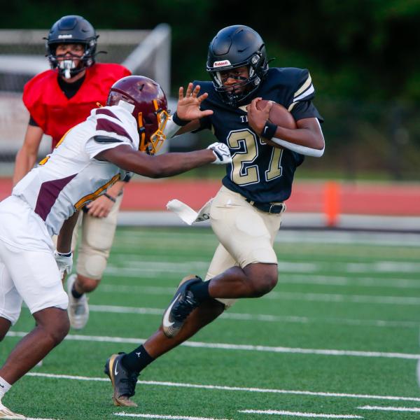 Greene County running back Johnathan Lawrence (27) prepares to stiff-arm a Hancock Central defender during last week’s scrimmage. LANCE McCURLEY/Staff