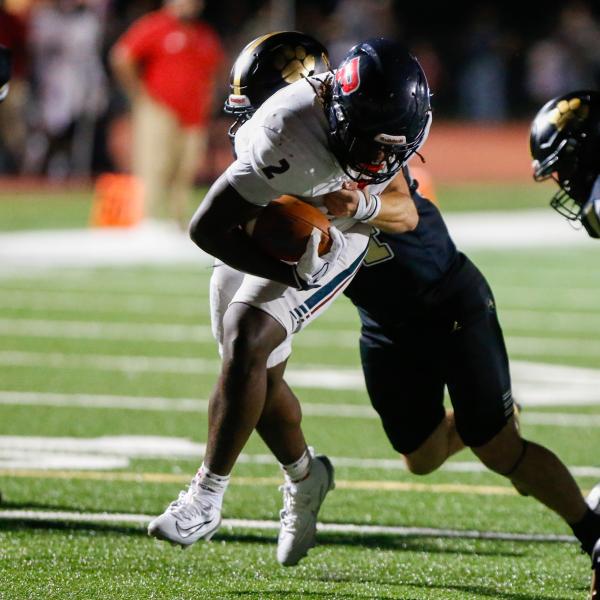 Putnam County junior running back Kumari Thomas (2) shrugs off a Greene County defender as he crosses the goal line for his second touchdown of the game. LANCE MCCURLEY/Staff