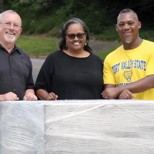 L-R: Kevin Tomson-Hooper is joined by Simone and Grady Jones, posing with the block of granite that will soon support a bronze statue of Eatonton’s own Hiram Little. IAN TOCHER/Staff
