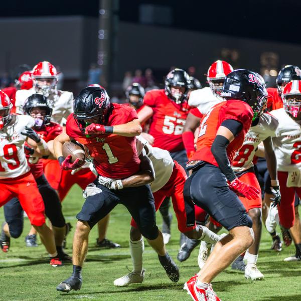 Dogs’ senior running back Alex Corrias shook off Madison County defenders in a scoring attempt during the season opener. SKYLA MORRIS/Staff