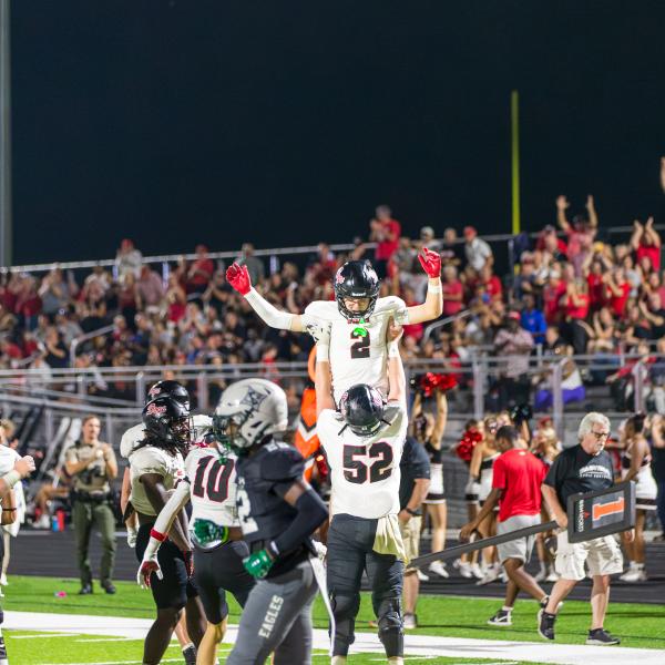 Morgan County senior offensive lineman Drew Breda (52) lifts up senior receiver Cole Wesley (2) after he scored a touchdown in last Friday’s win over Eastside. SKYLA MORRIS/Staff