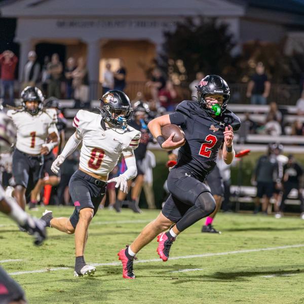 Dogs senior wide receiver Cole Wesley runs past a Hebron defender in attempt to score during their Sept 25 game. SKYLA MORRIS/Staff