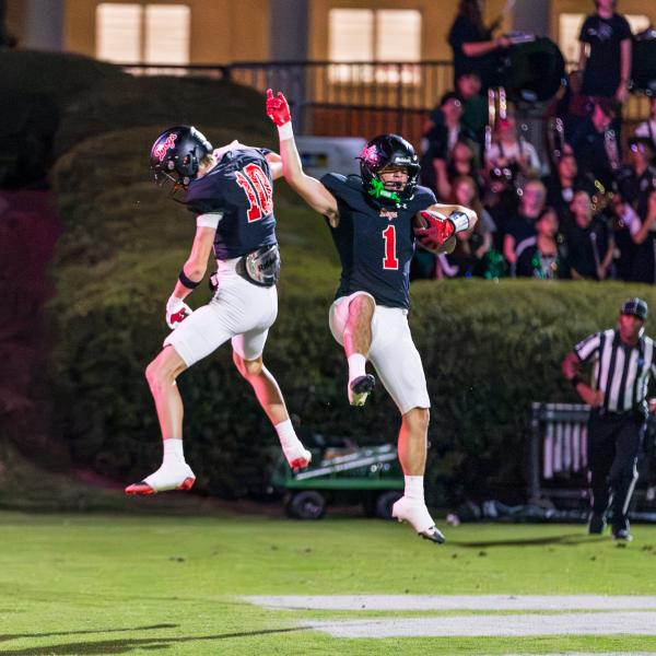 Morgan County senior running back Alex Corrias (1) celebrates his first touchdown of then night alongside junior wide receiver Kaden Morris (10). SKYLA MORRIS/Staff