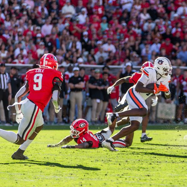 Auburn receiver Jeremiah Koger (4) gets away from Georgia’s Chris Cole (9) and Rasean Dinkins (14). SKYLA MORRIS/Staff