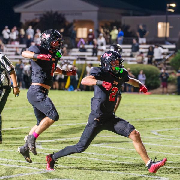 Dogs wide receiver Cole Wesley (2), celebrates his game-winning one-yard touchdown alongside running back Alex Corrias (1). SKYLA MORRIS/Staff