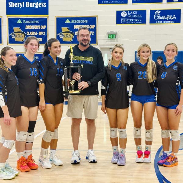 Lady Titans volleyball players and head coach Chris Ingle recieve the first-place trophy following the 2A Region 4 tournament. CONTRIBUTED