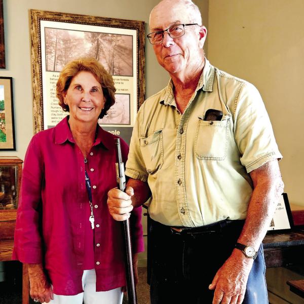 Retired judge LaVerne Ogletree and Bill Adams with a Civil War-era rifle. CONTRIBUTED
