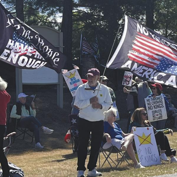 Protestors wave flags at the No Kings rally last Saturday in Greensboro. T. MICHAEL STONE/Staff