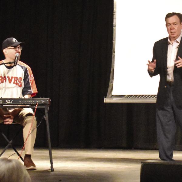 Atlanta Braves organist Matthew Kaminski (left) teamed up with “Mr. College Football” Tony Barnhart to entertain and talk some ‘ball with sports fans last Tuesday at Greensboro’s historic Festival Hall. T. MICHAEL STONE/Staff