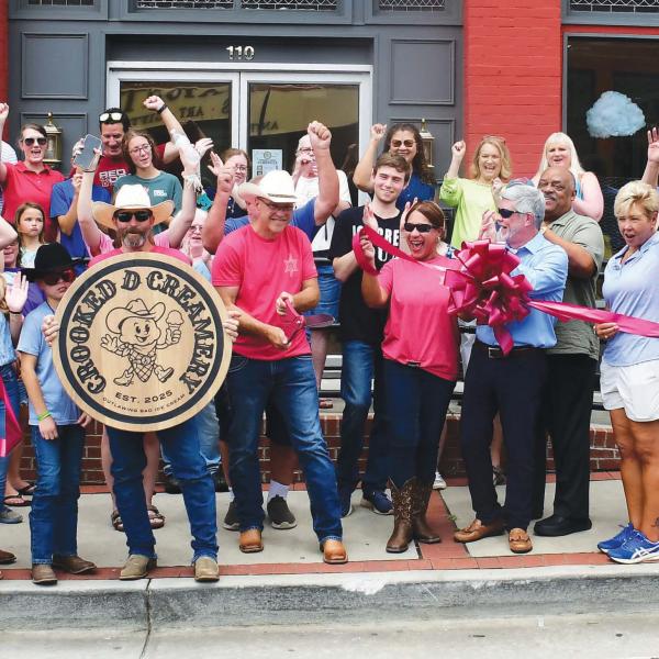 Crooked D Creamery founders and owners David Hodge (center, with scissors) and his wife, Jesse (center, sunglasses), welcomed a sizable crowd of well-wishers May 28 for their official ribbon cutting ceremony at 110 N. Jefferson Ave., in downtown Eatonton. IAN TOCHER/Staff