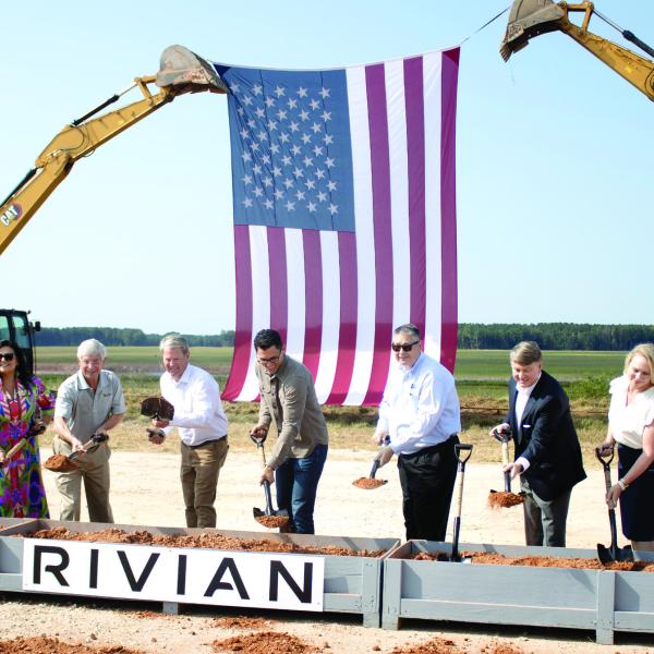 Rivian founder and CEO RJ Scaringe (third form left), with Georgia Gov. Brian Kemp to the right, helps break ground on the Stanton Springs project site in Social Circle, alongside several other state and local representatives. SKYLA MORRIS/Staff