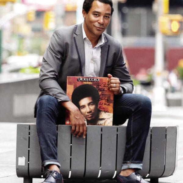 Singer Charl Brown poses on a New York street with one of Smokey Robinson’s record albums. CONTRIBUTED