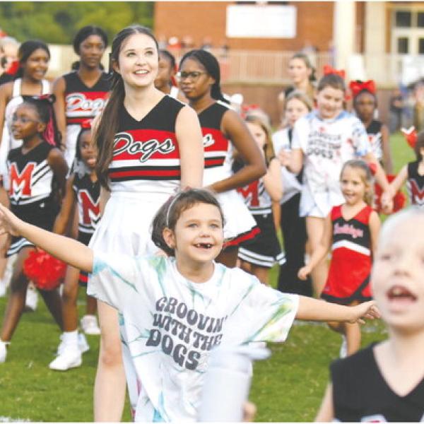 Morgan County youth football cheerleaders celebrate as confetti flies in the air. LANCE MCCURLEY/Staff