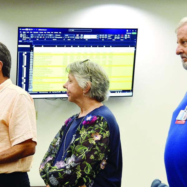 L-R: Putnam General Hospital Authority Board member Lou Benjamin, PGH Human Resources Director Rhonda Largo, and hospital CEO Alan Horton address county commissioners with detailed financial stats displayed on screens behind them. IAN TOCHER/Staff