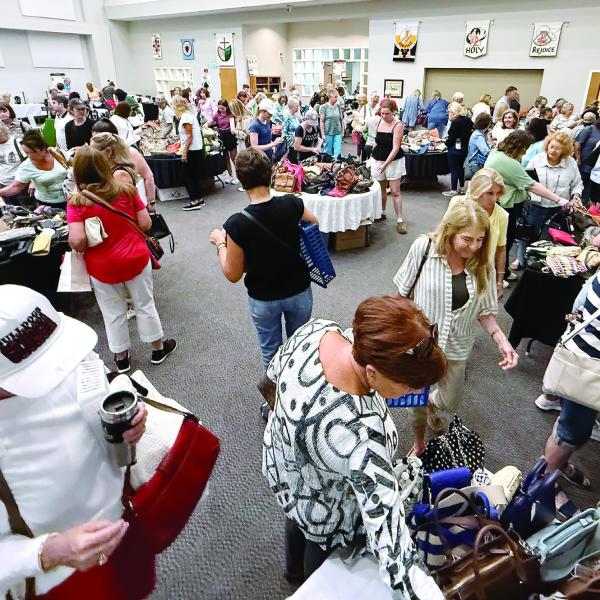 Women dominated the crowd at Upscale Resale, where donated, gently used, high-end pieces of jewelry, purses and carryalls, some clothing, and even a collection of fine jewelry was available for purchase to support local food pantries. IAN TOCHER/Staff