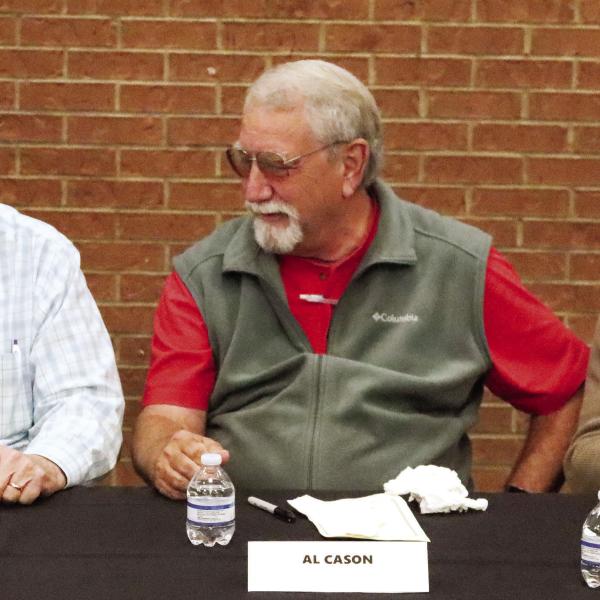 (From L to R): Dene Channell, Al Cason, and David Barnhart, who were all members of the 1970 Greene County High School football team, get set to sign books at the ceremony.