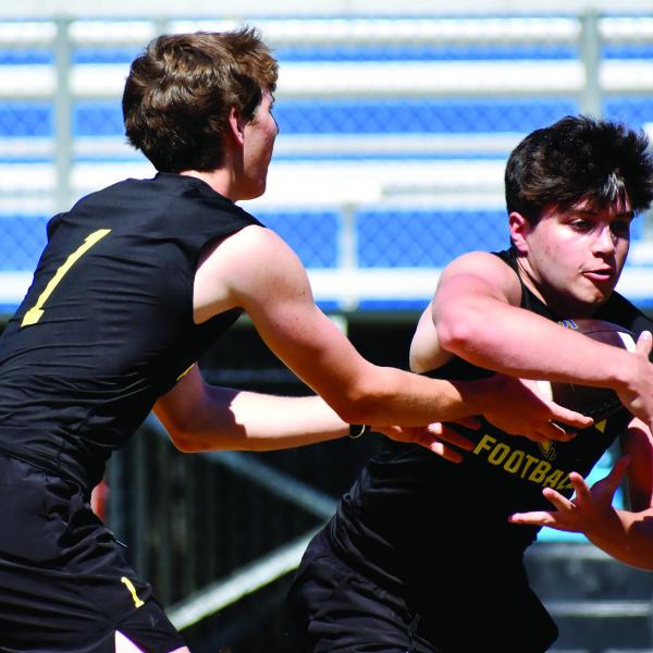 LOA quarterback Jake McDonald hands the ball off to running back Alden Barreras during a recent summer practice. CONTRIBUTED