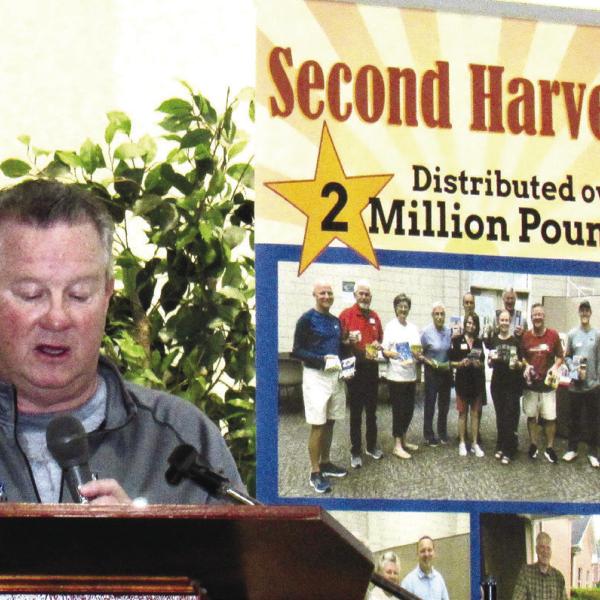 Second Harvest President Bill Bonnington congratulates volunteers and sponsors for helping achieve a record 2 million pounds of food distributed by the organization since 2008. MARK ENGEL/Staff