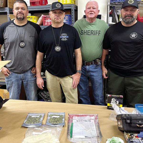 Morgan County Sheriff’s Investigators Sgt. Chase Young, Chad Lanier and Joseph Pritchett, and Putnam County Sheriff’s Investigator Lt. Harry Luke (in green shirt) show the drugs they worked to get off the streets. CONTRIBUTED