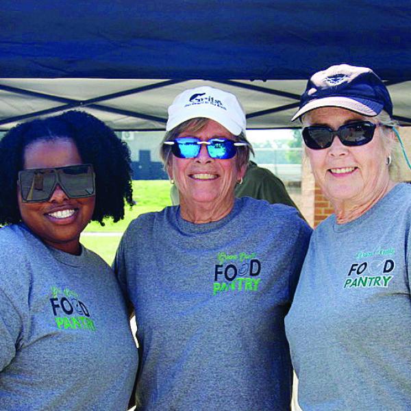 L-R: Greene County Food Pantry employee Daisy Bell, board member Becky Smith, and volunteer Mary Kay Landsberg represent the Pantry at the Summer Harvest Food Distribution at GCHS. CONTRIBUTED