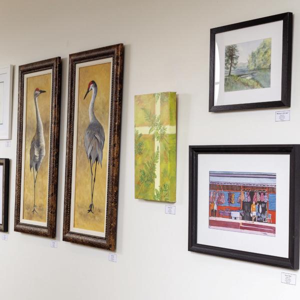 A variety of artwork hangs on the wall at Festival Hall in Greensboro and will remain on display for the next nine months. LEIGH LOFGREN/Staff