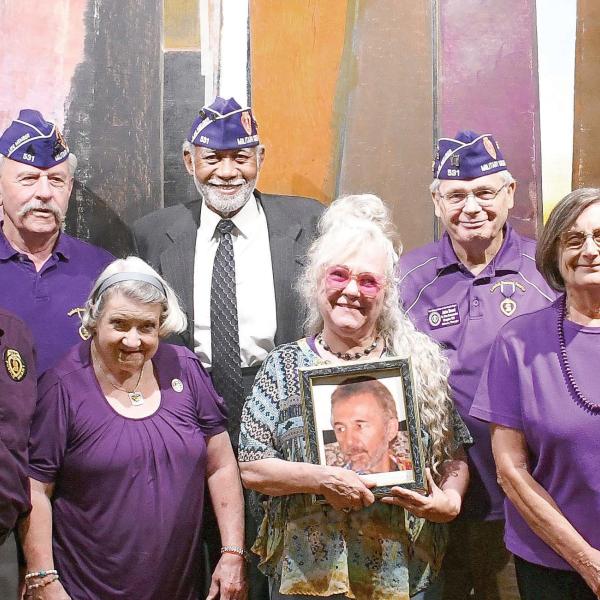 Members of the Athens-based John W. Hancock Memorial Chapter 531 of the Military Order of the Purple Heart pose with the daughter of Charlie Bonner Award for Advancing Education winner Richard “Ole” Olsen, holding a photo of her father. IAN TOCHER/Staff