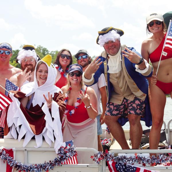 The Massey family and their friends celebrate winning the prize for the most decorated boat at last year’s boat parade. LANCE McCURLEY/Staff