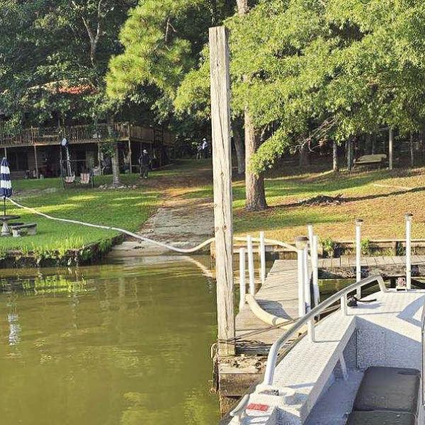 A hose supplies water from Putnam County’s fireboat in the lake to the ground trucks battling the blaze. This was the first time the fireboat has been used on a Putnam fire, although it has been used to provide mutual aid to Baldwin County Fire Department. CONTRIBUTED