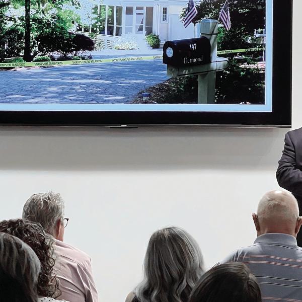 With a photo of the Dermonds’ Great Waters home on the TV mounted behind him, Putnam County Sheriff Howard Sills presents the evidence gathered so far in what he admits is the “toughest case” of his career so far. IAN TOCHER/Staff