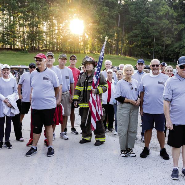 Walkers gather for a photo before making the mile-long walk. LEIGH LOFGREN/Staff