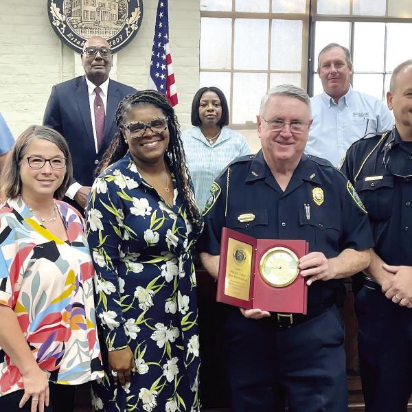 Interim Chief Roy Whitehead receives a token of appreciation from the Madison City Council (l-r Betsy Wagenhauser, Ed Latham, Mayor Fred Perriman, Carrie Peters-Reid, Rick Blanton and Eric Joyce) as well as CFO Karen Stapp and Human Resources Director Karen Robertson. (T. MICHAEL STONE/Staff)