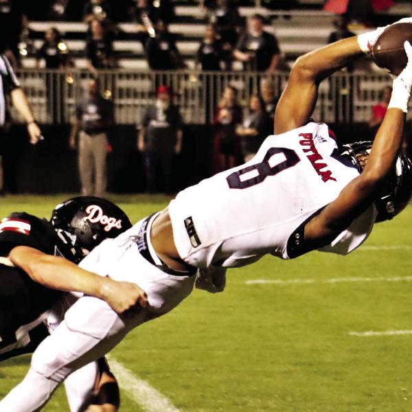 Cedrion Brundage bends over backwards to break the goal line plane and score Putnam County’s first touchdown of the 2021 season against the Morgan County Bulldogs, leading to a 37-0 rout. ARELLA CASH/File photo
