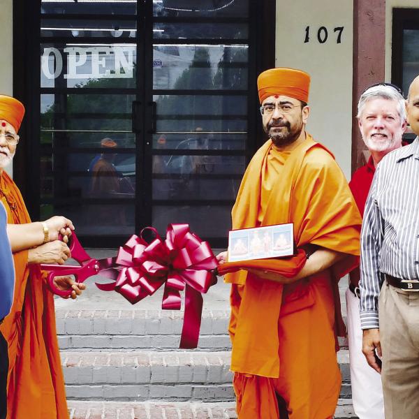 Store owner Neil Patel (third from left) was joined by Eatonton Mayor John Reid (blue shirt), two “saints” from BAPS Mandir, and Eatonton-Putnam Chamber of Commerce CEO Robbie King (red shirt), among others, for a Memorial Day ribbon cutting at Stop N Go, on Eatonton’s Martin Luther King Jr. Drive. IAN TOCHER/Staff