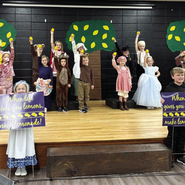 Dressed as Lemonade storybook characters, young Gatewood actors hold up lemons while others display signs reminding everyone: “When life gives you lemons, make lemonade!” EMME CLAUSE/Staff