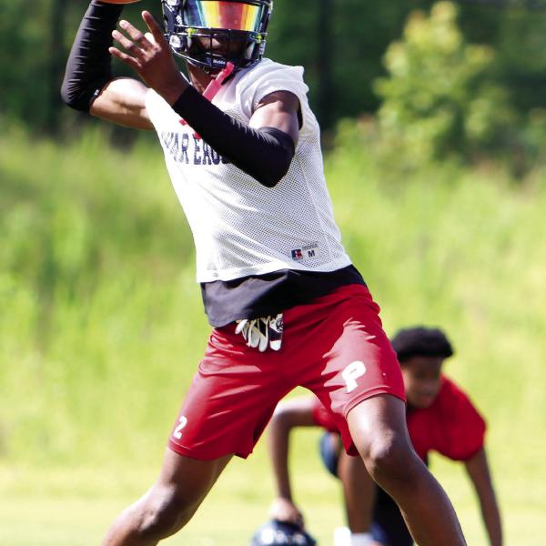 Putnam County quarterback Jamarion Robertson drops back to pass during a practice in June. (LANCE MCCURLEY/Staff)