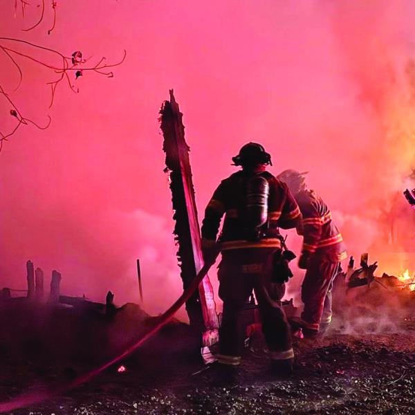 Putnam County Fire Department firefighters extinguish what was left of a fire that burned this detached garage to the ground last week. CONTRIBUTED